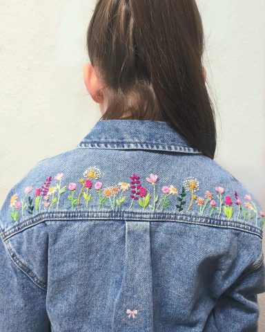 Garden on Denim - Hand-embroidered Denim Jacket for Women Back of a denim jacket featuring colourful floral embroidery.