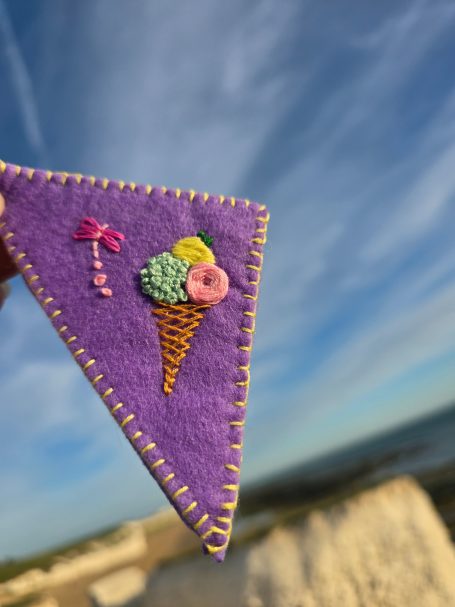 Purple felt corner bookmark with an embroidered ice cream cone and a dragon-fly