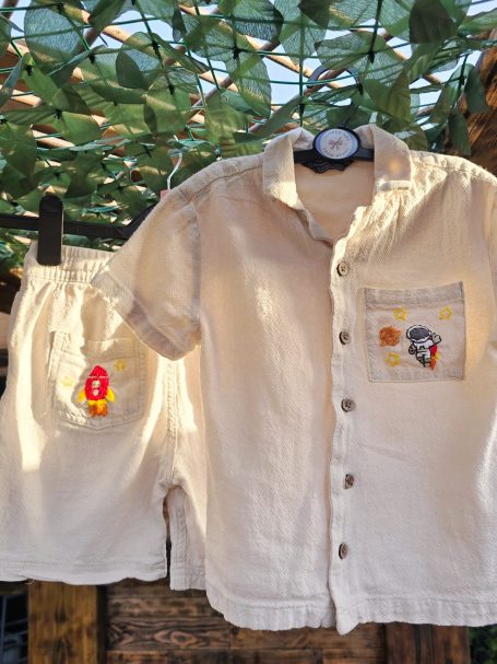 Beige summer outfit for 5-6-year-old boys with embroidered space-themed details (astronaut, rocket, planet, stars)