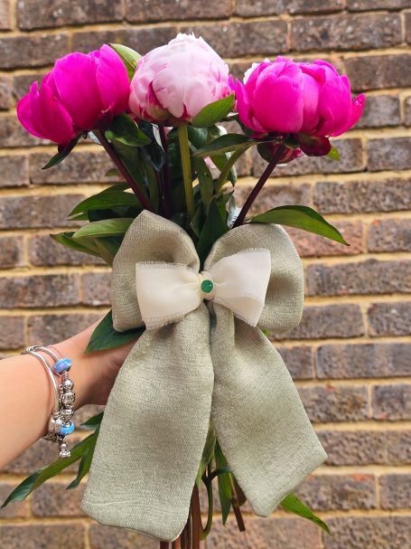 Handmade sage green big bow with with a natural agate in the center.