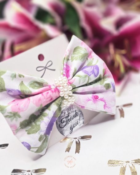 Handmade floral fabric mini hair clip featuring pastel flowers on a neutral cream background