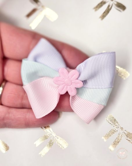 Handmade mini hair clip in three pastel colours (pink, blue, purple) with a pink tiny flower in the center.