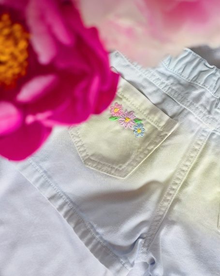 Denim shorts for 2-3 year-old girls with pastel floral embroidery.