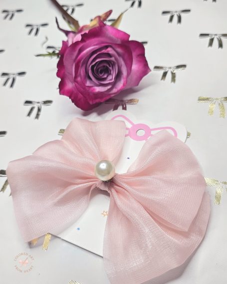 Handmade blush pink fabric mini hair clip photographed on a neutral cream background