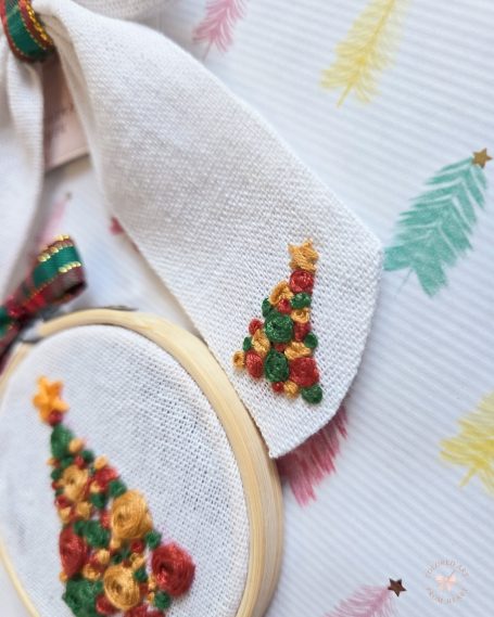 Christmas set including white linen  bow with tartan centre and embroidered Christmas tree and stars, and matching embroidered decoration