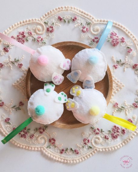 Collection of four funny bunny backsides charms in white and pastel colours.