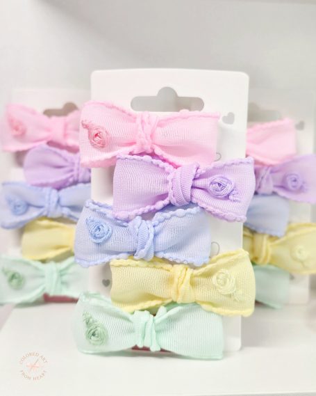 Handmade hair set featuring five pastel mini bows, each embroidered with a matching rose. In pastel pink, lilac, blue, yellow and mint green